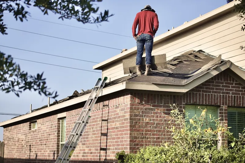 Professional roofer working on a residential roof in Hulen Mall